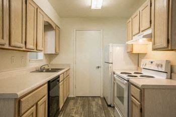 a kitchen with a stove a refrigerator and a sink